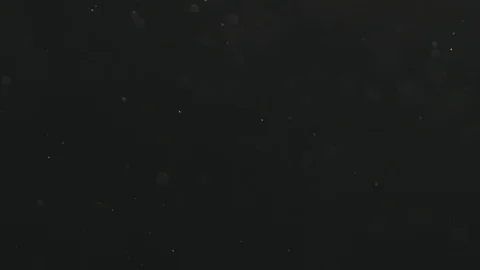 Slow motion dust particles floating over black background Stock Footage 104332992