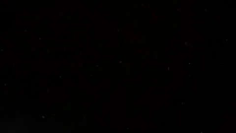 Slow Motion of Dust Particles Floating in Air Isolated on Black, Atmospheric Video stock 342408833