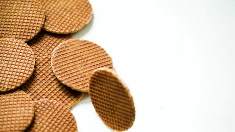 Slow Motion Dutch Stroopwafel Drop, Round Caramel Cookies Spread on Table 스톡 동영상 313491688