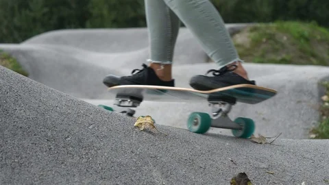 SLOW MOTION Dynamic close-up shot of woman on a skateboard riding fast Stock Footage 118930562