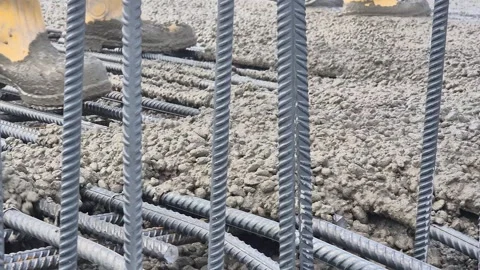 Slow Motion Dynamic Concrete Pouring on Steel Mesh Stock-Footage 336430372