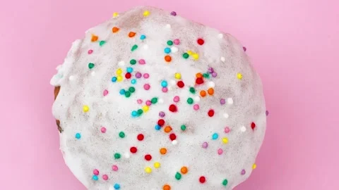 Slow motion of easter cupcake with white frosting and multicolored confett Stock Footage 149043356