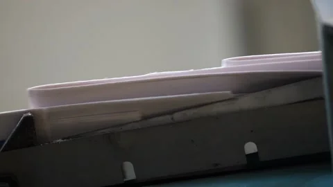 Slow motion edges of newspapers moving along conveyor at printers Stock Footage 156227422