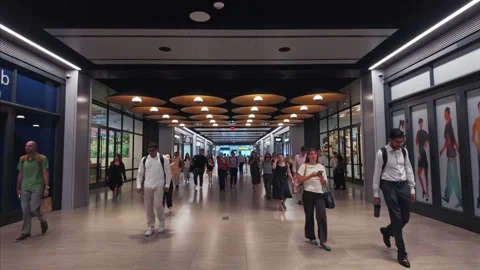 Slow-motion editorial of commuters walking through Moynihan Train Hall in NYC Stock Footage 341006392
