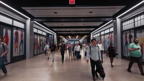 Slow-motion editorial of commuters walking through Moynihan Train Hall in NYC Stock Footage 341006426