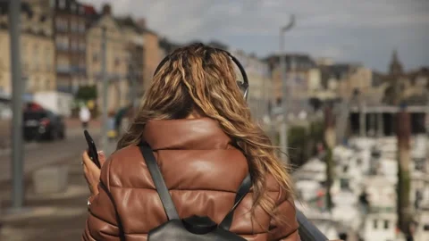 Slow motion effect of hipster user of electronic earphones and cellphone device Stock Footage 135616318