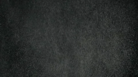 Slow motion effect of powder, dust, snow particles falling on black background Stock Footage 141423168