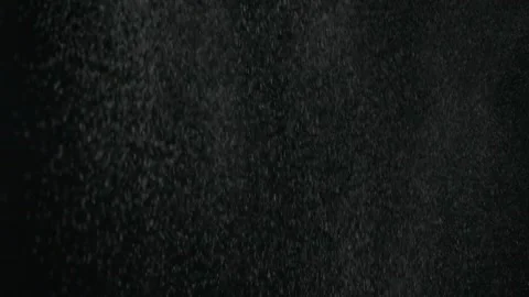 Slow motion effect of powder, dust, snow particles falling on black background Stock Footage 143310212