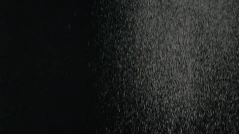 Slow motion effect of powder, dust, snow particles falling on black background Stock Footage 146677992