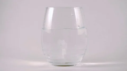 Slow Motion Effervescent Tablet Drops into Water Glass Stock Footage 74608710