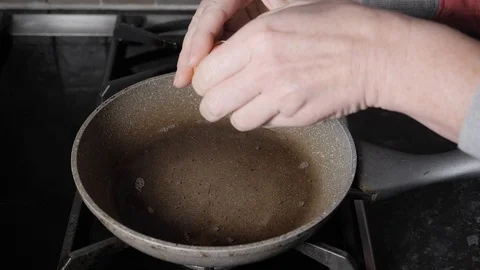 Slow Motion Egg Being Broken Into Frying Pan Stock Footage 105719743