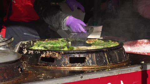 Slow motion of egg cracked on oyster mix at Taichung night market Stock Footage 310673134