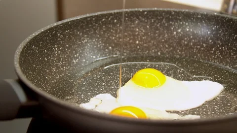 Slow motion egg frying in pan Stock Footage 130062043