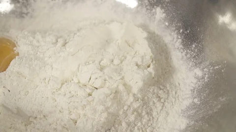 Slow motion Egg Yolk falling into flour Stock Footage 85875704