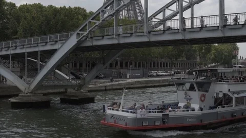 SLOW MOTION: Eiffel Tower appears behind bridge on boat cruise in Paris Stock Footage 105166183