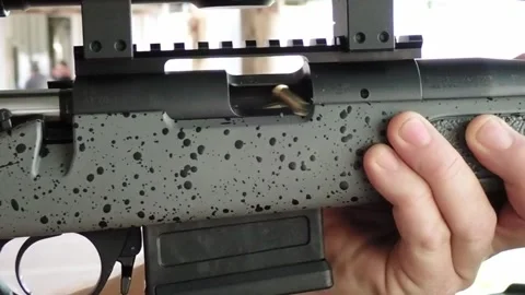 Slow motion ejecting used rifle cartridge from chamber 動画素材 311834072
