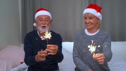 Slow motion, an elderly couple playing fireworks while having fun. Stock Footage 117995968