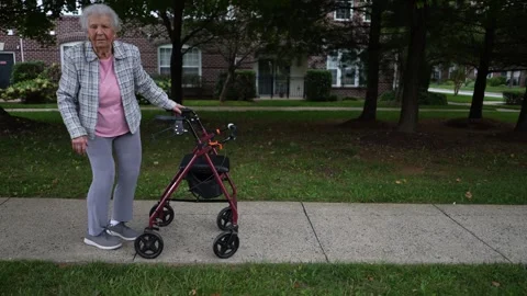 Slow motion of elderly senior old woman taking a rest while using walker for Stock Footage 253404727