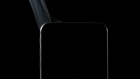 SLOW MOTION: Elegant smoke stream from smartphone - Close up Vídeo Stock 72374382