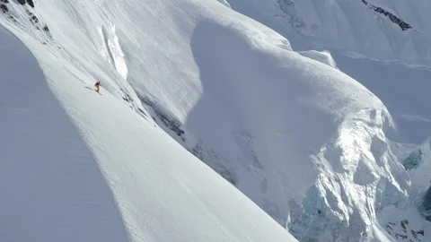 Slow motion of Elite skier freeriding in extreme conditions of Alaska Stock Footage 129120349
