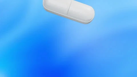 Slow motion ellipse white tablets falling Stock Footage 138430542
