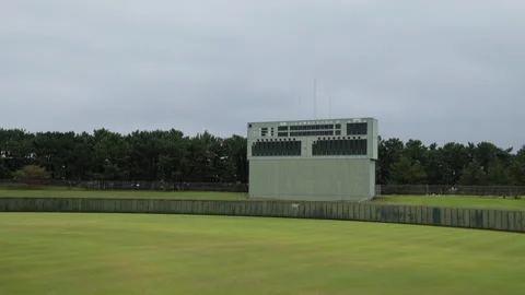 Slow motion empty baseball field with scoreboard and pines in Japan Video stock 348586198