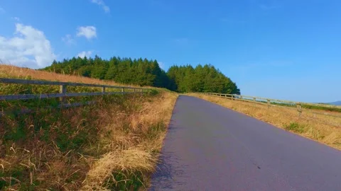 Slow motion empty country asphalt road leading through green hills Stock Footage 340441201