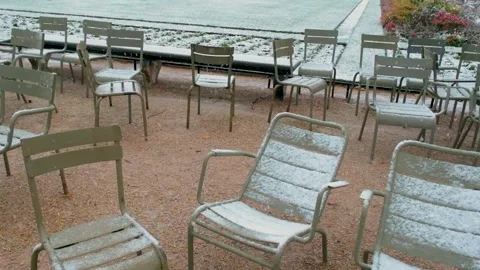 Slow-motion of Empty Metal Chairs in Luxembourg Gardens Covered in Snow Stock Footage 317676398