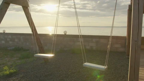 Slow motion, Empty swing set swing, silhouette at sunset. Stock Footage 136728064