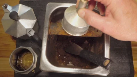 Slow motion  Emptying grounds from a stovetop coffee filter basket. Stock Footage 200879710