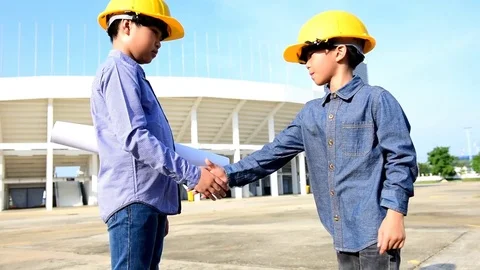 Slow motion Engineer boy wearing yellow safety helmet and shaking hand Stock Footage 75819359