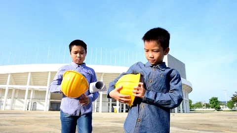 Slow motion Engineer boy wearing yellow safety helmet. Stock Footage 77631774