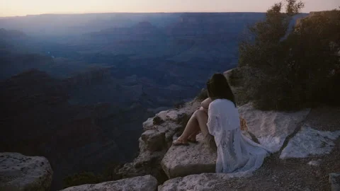 Slow motion epic background shot of happy young woman with flying hair sitting Stock Footage 102647830