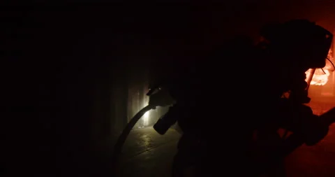 Slow Motion Epic Firefighter Crawling Into Burning Warehouse To Extinguish Fire Stockbeeldmateriaal 229898749