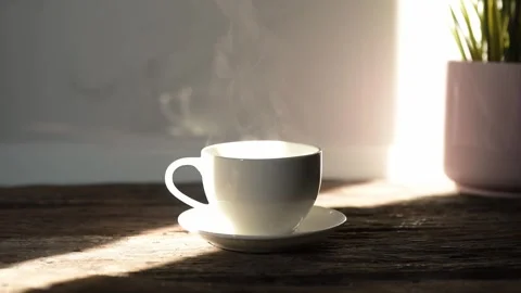 Slow motion espresso and hot coffee mug in sunlight cozy indoor environment Stock Footage 296997730