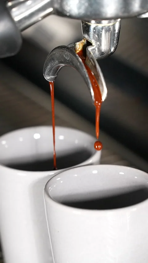 Slow Motion Espresso Begins Brewing into Cups in Close Up Stock Footage 313542980