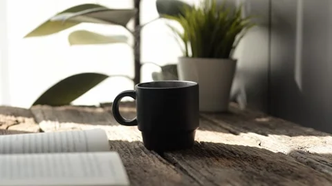 Slow motion espresso in a black mug cozy coffee nook hot drink concept indoor Stock Footage 296997873