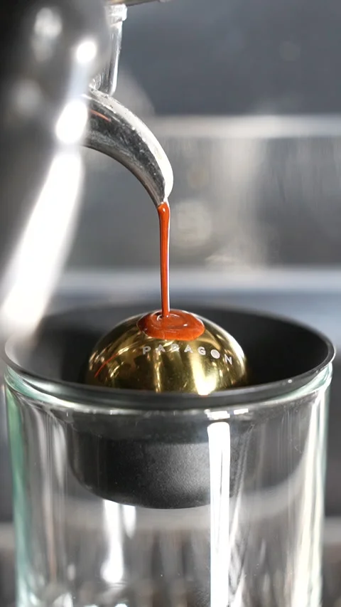 Slow Motion Espresso Coffee Begins Brewing on Cold Paragon Sphere in Close Up Stock Footage 313542977
