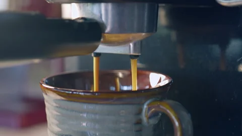 Slow motion espresso coffee pouring from machine into ceramic cup for fresh.. Stock Footage 336944481