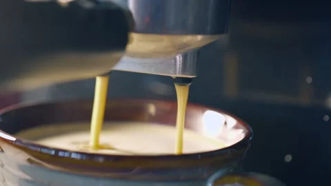 Slow motion espresso coffee pouring from machine into ceramic cup for fresh.. Stock Footage 336944524