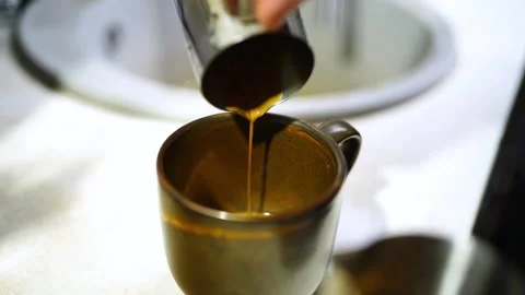 Slow Motion Espresso Pouring at 100 FPS from Pitcher into Cup Stock Footage 312260931