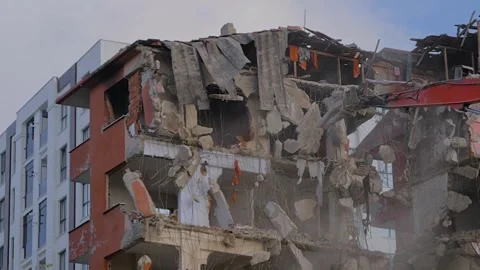 Slow motion: excavator with hydraulic crusher is tearing down the building Stock Footage 337067148