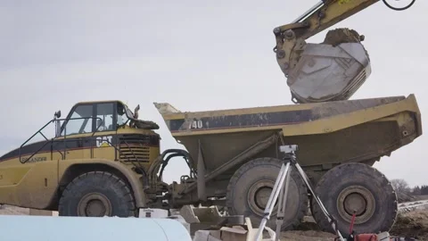 Slow Motion Excavator Pouring Dirt Into Dump Truck Stock Footage 144904953