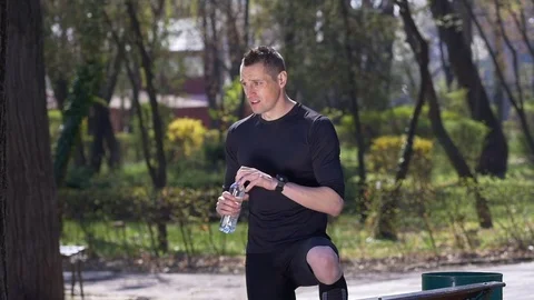 Slow motion of exhausted jogger drinking water from bottle after finishing hi Stock Footage 77738174
