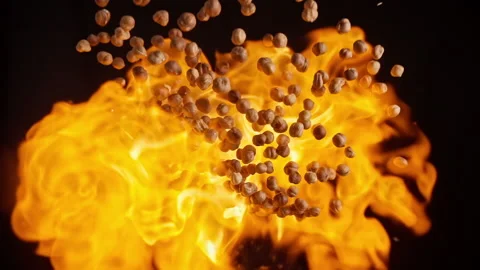 Slow motion explosion of hazelnut flying in flames Stock Footage 148179307