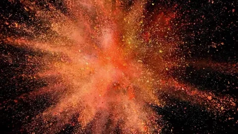 Slow motion explosion of orange powder on a black background closeup. Stock-Footage 346914230