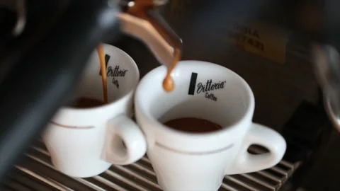 Slow motion expresso coffee coming out of portafilter Stock Footage 237243519
