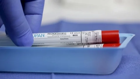 Slow Motion Extreme Close Up of Gloved Health Care Worker Picking Up COVID S Stock Footage 129412284
