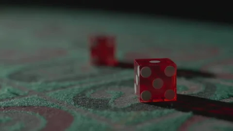 Slow motion extreme close-up red dice thrown left Видео 335699916