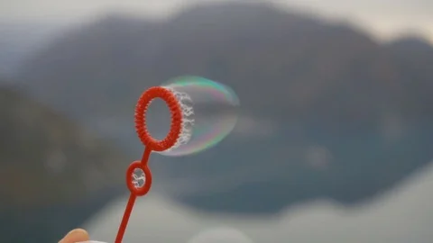 Slow motion, extreme closeup blowing soap bubbles Stock Footage 82882857